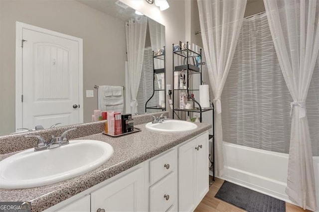 bathroom featuring vanity, hardwood / wood-style flooring, and shower / bath combo