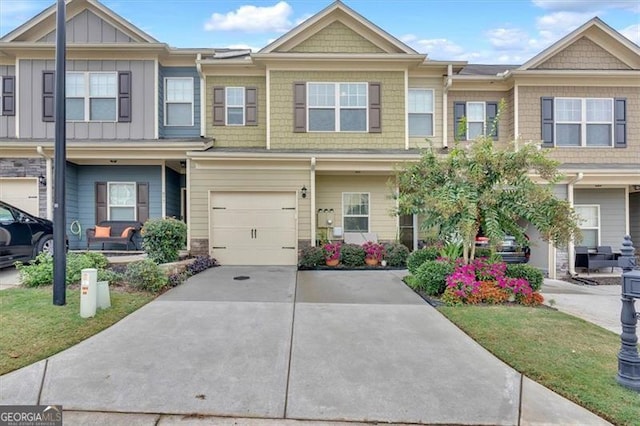 view of property featuring a front yard and a garage