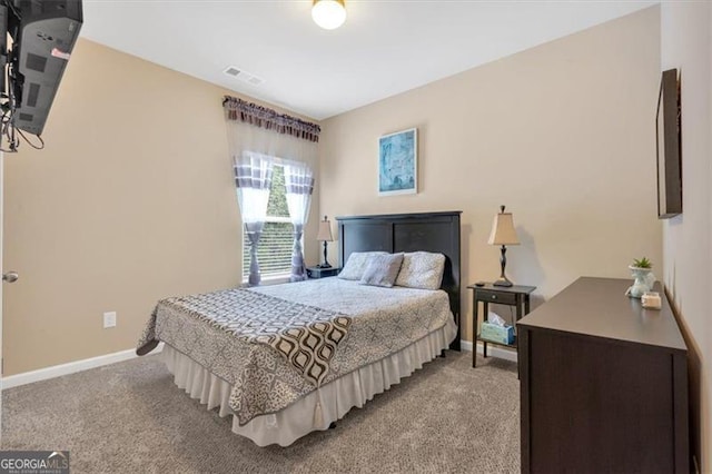 bedroom featuring light carpet