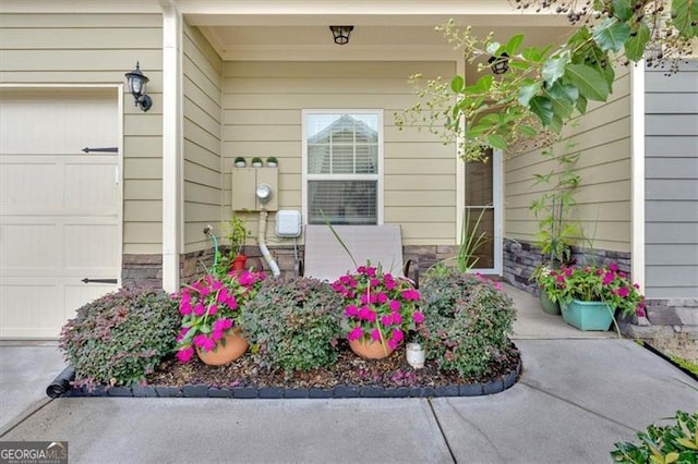 view of exterior entry with a garage