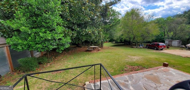 view of yard featuring a garage and a fire pit