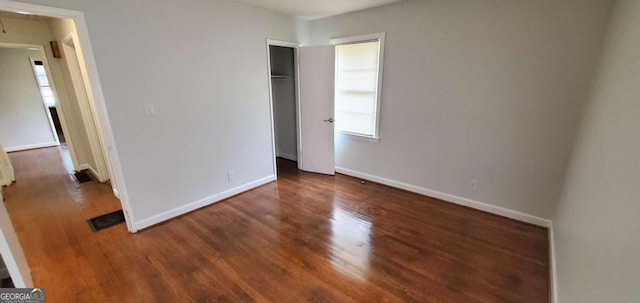 unfurnished bedroom with dark hardwood / wood-style floors