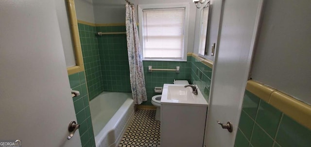 full bathroom with vanity, toilet, shower / bath combination with curtain, and tile walls