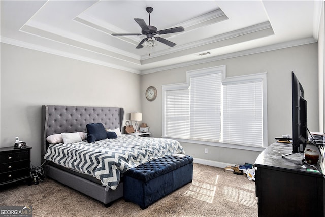 carpeted bedroom featuring ornamental molding, ceiling fan, and a raised ceiling