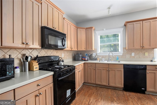 421 Bedford Xing, Mcdonough, GA 30253 - kitchen with black appliances, wood finished floors, light brown cabinets, light countertops, and decorative backsplash