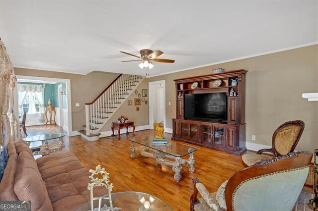 living room featuring ceiling fan, hardwood / wood-style floors, and a fireplace