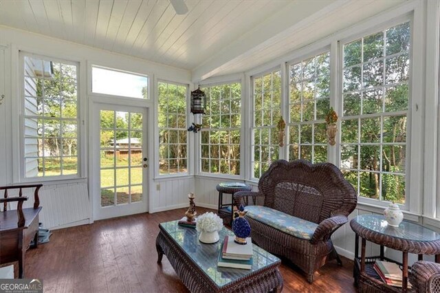 sunroom featuring ceiling fan and wooden ceiling