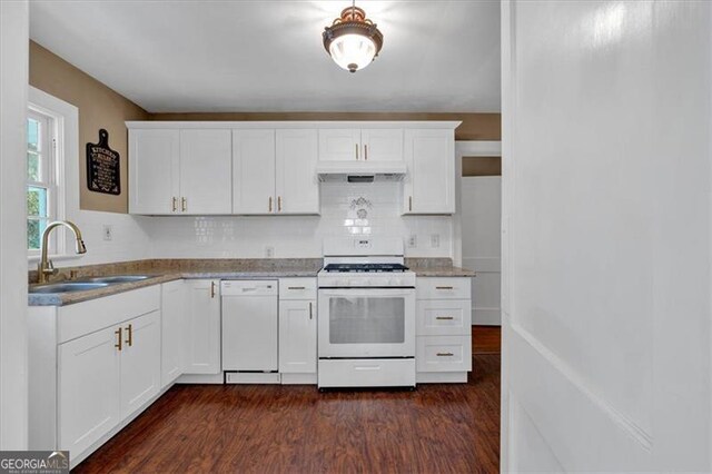 kitchen featuring white appliances, decorative backsplash, sink, white cabinets, and dark hardwood / wood-style flooring