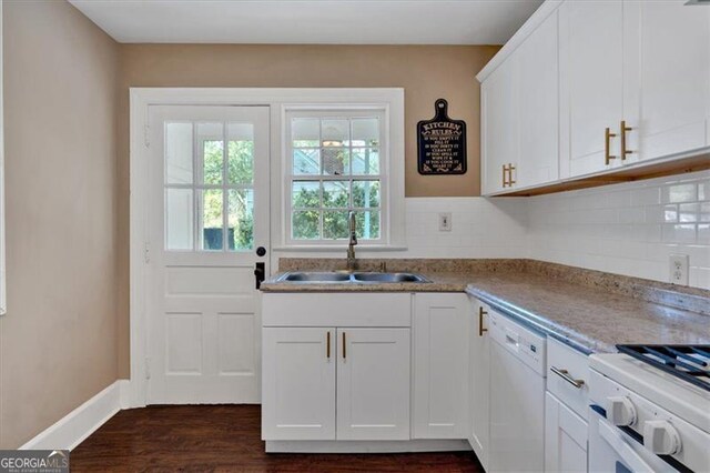 kitchen with white cabinets, white dishwasher, tasteful backsplash, and sink