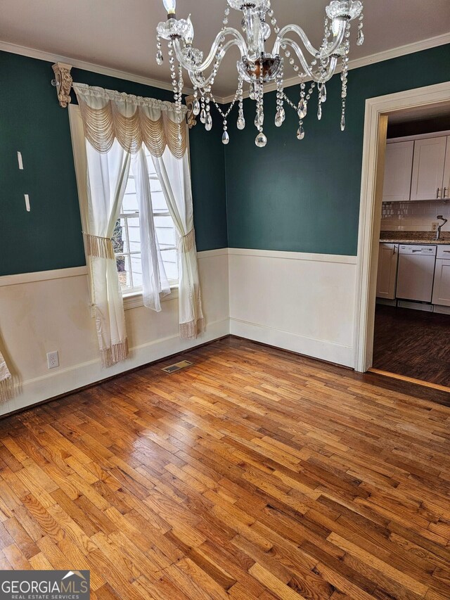 laundry area with wood-type flooring and washer and clothes dryer