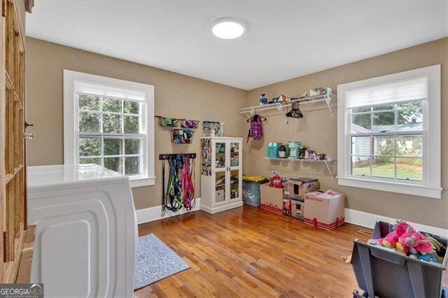 bedroom with multiple windows, hardwood / wood-style flooring, and ceiling fan