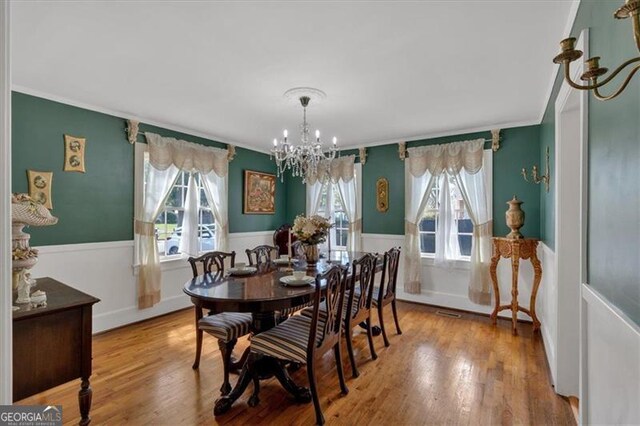 living room with a healthy amount of sunlight, light hardwood / wood-style flooring, a fireplace, and crown molding