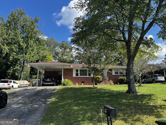 ranch-style home with a front yard and a carport