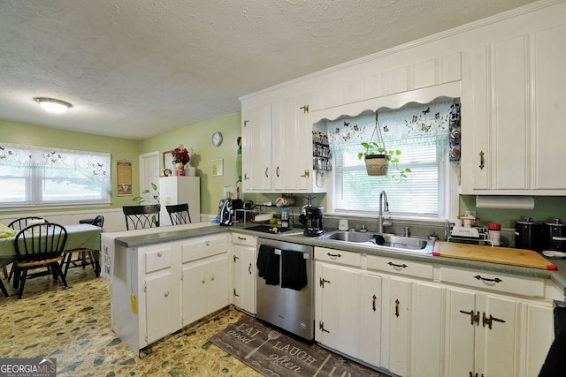 kitchen featuring a textured ceiling, dishwasher, sink, and white cabinets