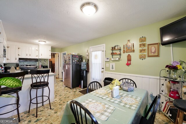 dining room with a textured ceiling