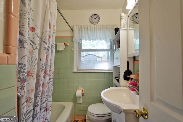 full bathroom with tile walls, vanity, toilet, and shower / bathtub combination with curtain