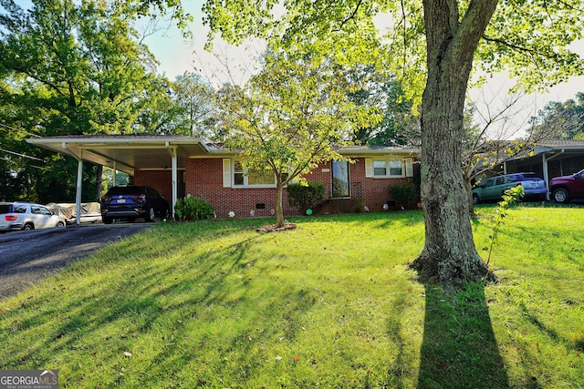 single story home with a front yard and a carport