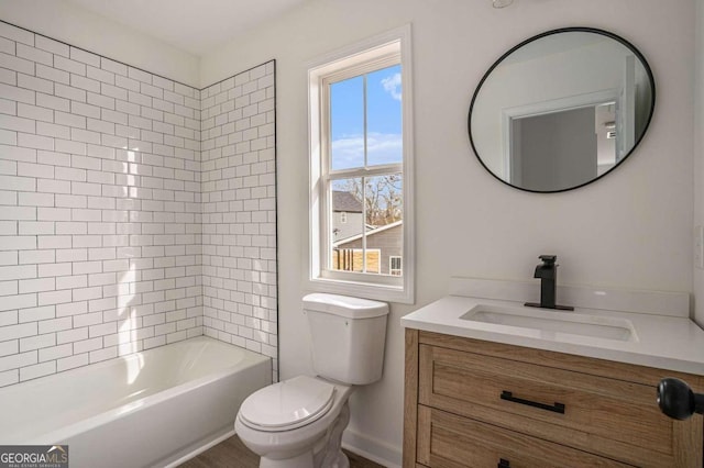 full bathroom featuring vanity, toilet, and tiled shower / bath