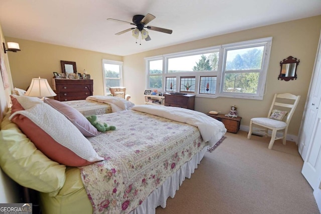 bedroom with light colored carpet and ceiling fan