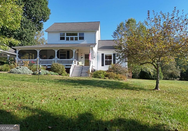 view of front of house featuring covered porch and a front lawn