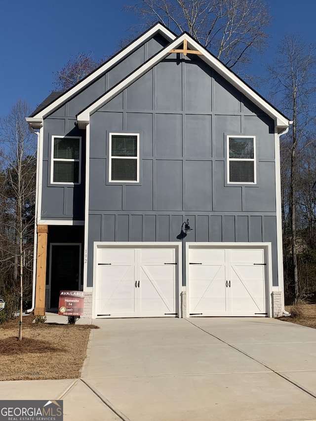 view of property exterior with board and batten siding and driveway