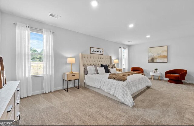 bedroom with recessed lighting, visible vents, baseboards, and light colored carpet