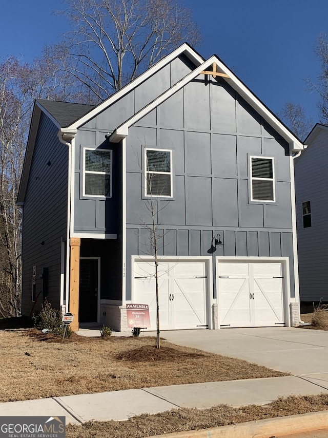 view of front facade with driveway, an attached garage, and board and batten siding