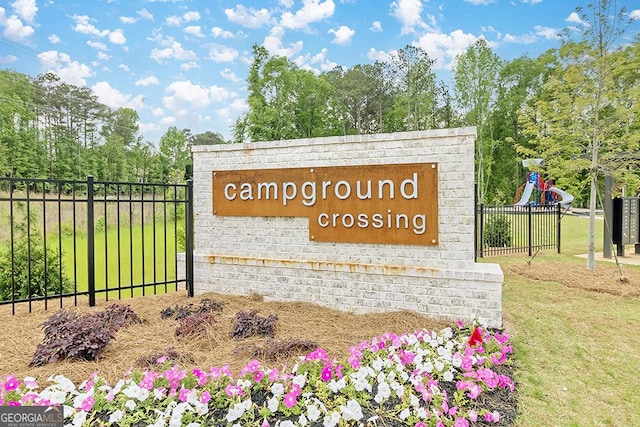 community / neighborhood sign featuring fence