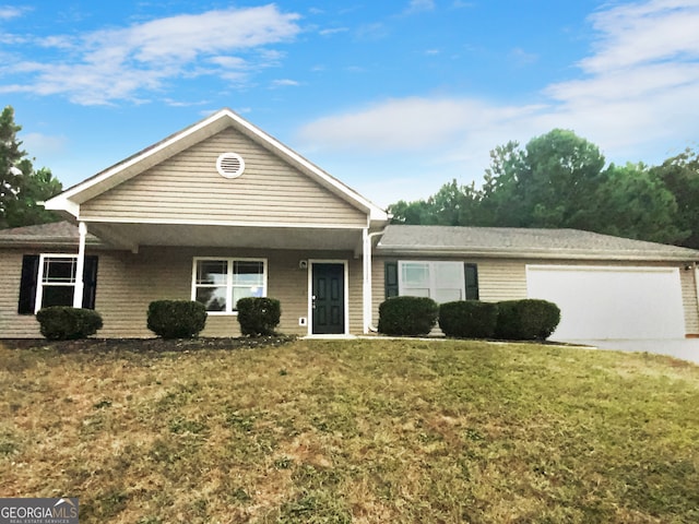 view of front facade featuring a garage, covered porch, and a front lawn