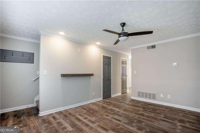 empty room with crown molding, dark hardwood / wood-style floors, a textured ceiling, and ceiling fan