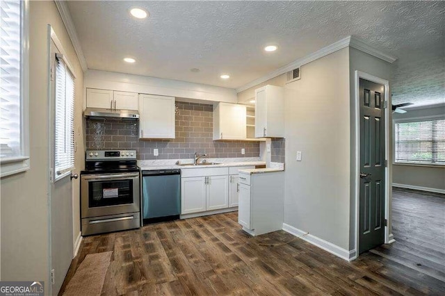 kitchen featuring appliances with stainless steel finishes, a textured ceiling, white cabinets, and dark hardwood / wood-style flooring