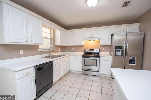 kitchen with a textured ceiling, sink, white cabinetry, appliances with stainless steel finishes, and light tile patterned floors