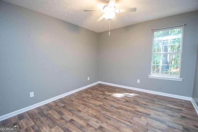 unfurnished room featuring a textured ceiling, ceiling fan, and dark hardwood / wood-style flooring