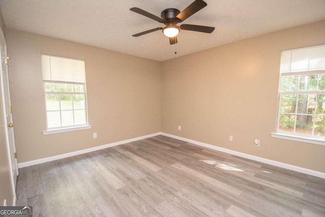 empty room featuring wood-type flooring and ceiling fan