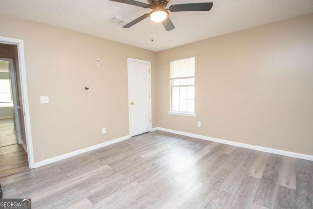 empty room featuring light wood-type flooring and ceiling fan