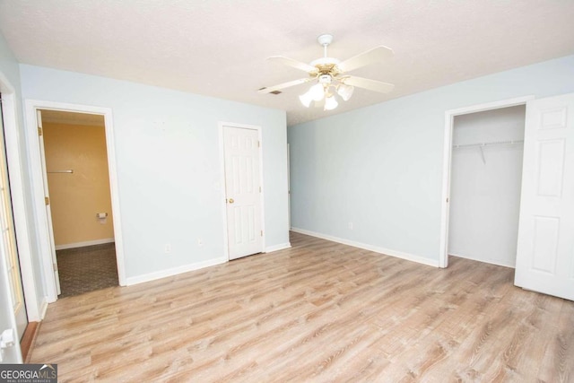 unfurnished bedroom featuring light wood-type flooring and ceiling fan