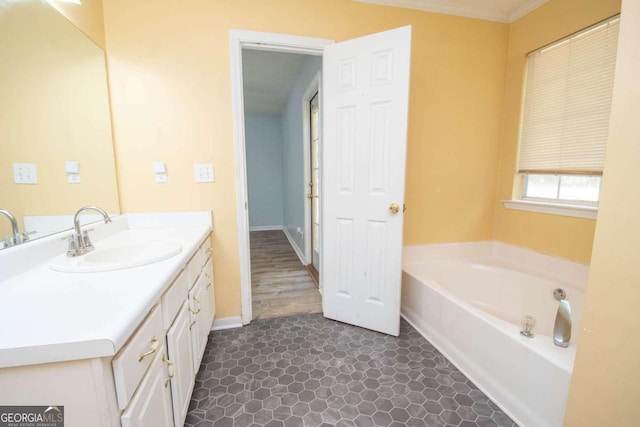 bathroom featuring hardwood / wood-style flooring, vanity, and a bathing tub