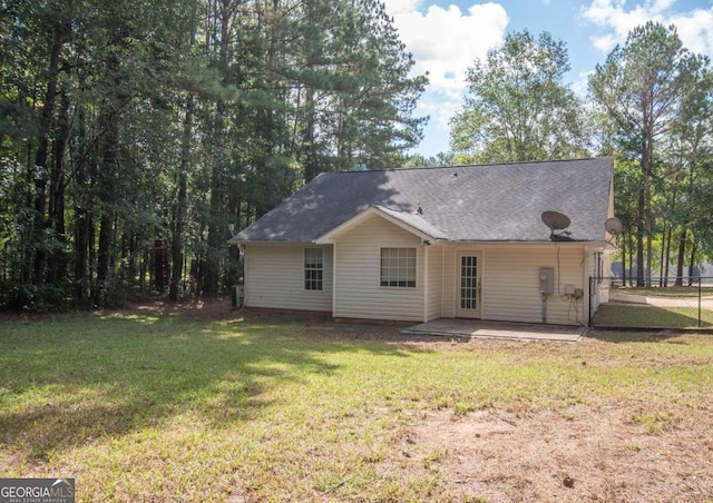 back of house featuring a patio area and a yard