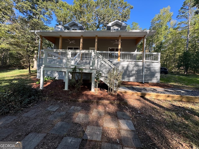 view of front of house with a deck and ceiling fan