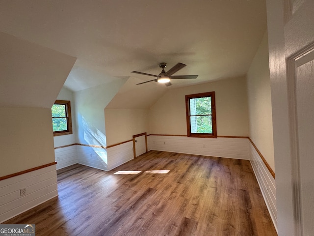 bonus room with a healthy amount of sunlight, vaulted ceiling, ceiling fan, and light hardwood / wood-style flooring