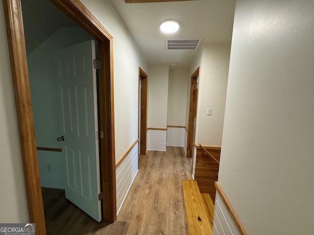 corridor featuring light wood finished floors and visible vents