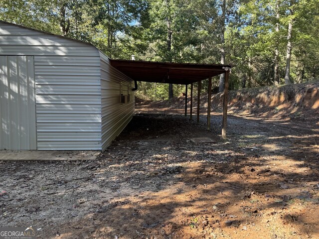 view of outdoor structure featuring an attached carport