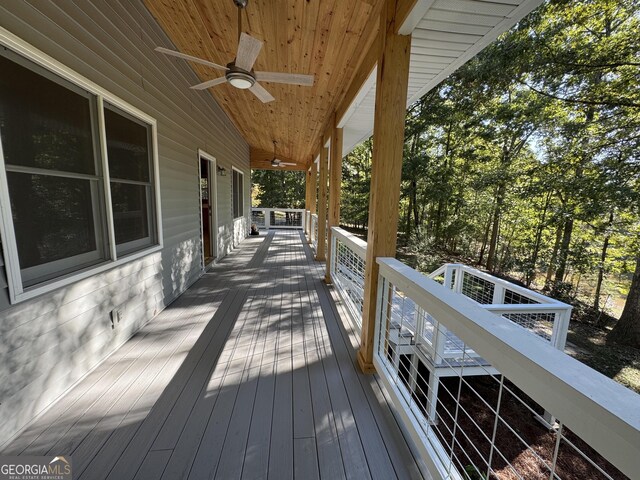 wooden deck featuring ceiling fan