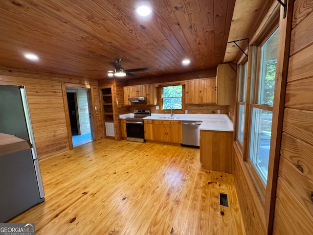 kitchen featuring sink, range hood, light hardwood / wood-style flooring, appliances with stainless steel finishes, and wooden ceiling