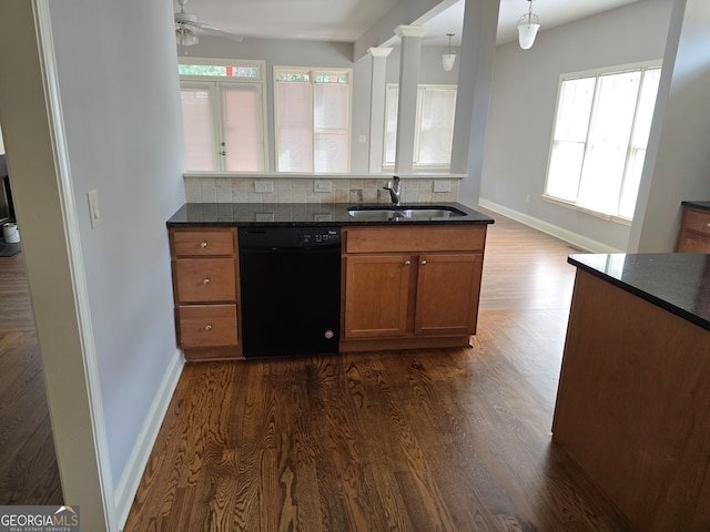 kitchen with pendant lighting, dishwasher, sink, backsplash, and dark hardwood / wood-style flooring