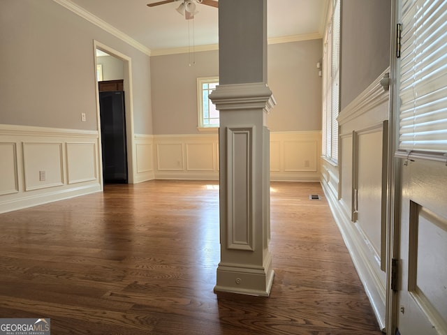 unfurnished living room with ceiling fan, ornamental molding, hardwood / wood-style flooring, and decorative columns