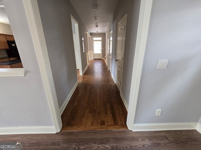 corridor with dark hardwood / wood-style floors