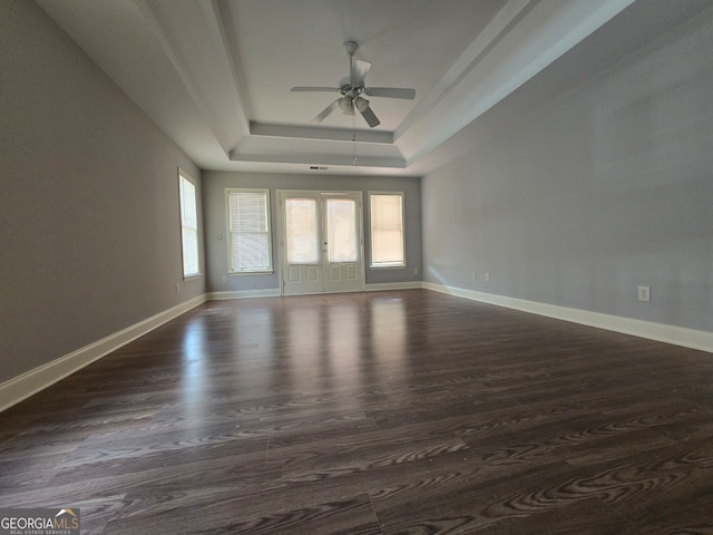 spare room featuring ceiling fan, a tray ceiling, french doors, and dark hardwood / wood-style flooring