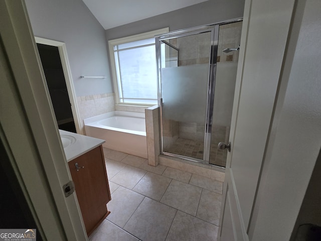 bathroom with independent shower and bath, vanity, lofted ceiling, and tile patterned flooring