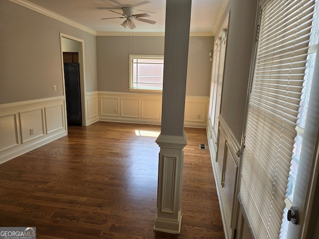 unfurnished room featuring ornamental molding, decorative columns, ceiling fan, and dark hardwood / wood-style flooring